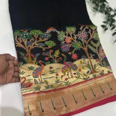 Our Dola Paithani saree in a timeless black. The vibrant, multi-colored weaving on the pallu creates a breathtaking contrast.