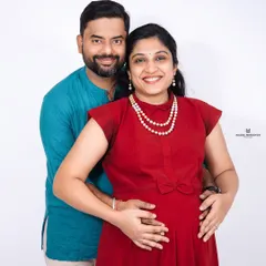 A slight variation in outfit, a world of love. This studio portrait shows the couple in a mix of traditional and modern attire, celebrating their journey together.