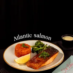 For something a little lighter, try my grilled Atlantic Salmon. It’s cooked to perfection and served with rice and steamed broccoli.