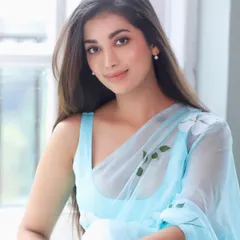 A beautiful portrait of Digangana in a light blue saree. The soft glam makeup, with its luminous finish and neutral tones, perfectly complements the serene and graceful vibe of the outfit.