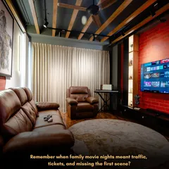 Forget traffic and tickets. I can bring the blockbuster experience right into your home. This is a custom home theatre I designed, complete with plush leather recliners, ambient track lighting, and an exposed brick wall for that rustic, industrial vibe.