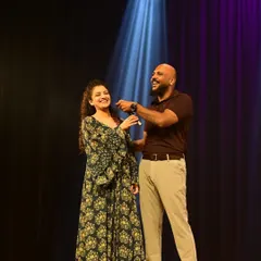 The director and a guest on stage during our "Moments of Magic" showcase. This event brought together over 1200 performers and 4000 audience members across two cities.