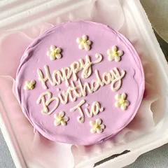 A lovely floral "Happy Birthday" bento cake. The simple daisy design and pastel purple frosting make this a very popular choice for a cute and personal birthday treat.