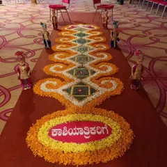 A beautiful floral carpet, or rangoli, created for a Kashi Yatre ceremony. The intricate pattern is made with marigold and tuberose petals, welcoming the groom on his symbolic journey.