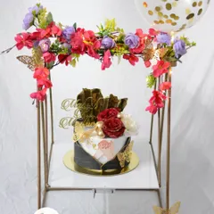 An elegant gift set for an engagement or anniversary. The beautiful cake is presented under a floral arch with a matching confetti balloon, creating a stunning visual centerpiece.