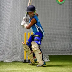 A young batsman, fully padded, with intense focus on the incoming ball. This "eyes on the prize" mentality is what we cultivate in our youngest players.