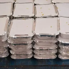 Stacks of freshly packed meals, sealed and ready for dispatch. We can handle high volume orders with ease.