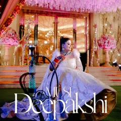 A regal portrait of the bride Deepakshi, seated gracefully in her elaborate gown next to a modern hookah, blending tradition with contemporary style.