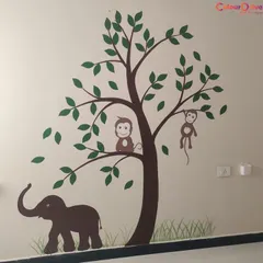 A playful stencil design in a child's room featuring an elephant and monkeys in a tree. This simple and charming nature scene adds a fun, storytelling element to the space.