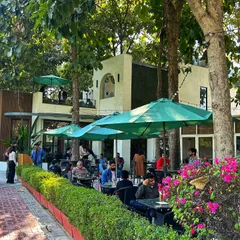 A wide shot of our bustling cafe patio, a popular spot for both golfers and food lovers to enjoy the outdoors.