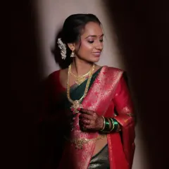 A beautiful, traditional sakarpuda (engagement) look. The makeup is subtle and glowing, letting the classic Paithani saree and gold jewelry shine.