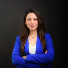 A professional studio portrait for a doctor. The clean, dark background and direct gaze create a sense of trust and competence, essential for a medical professional's branding.