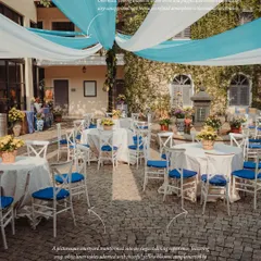 A picturesque courtyard transformed into an elegant dining experience for a Mehendi. We used crisp white linens, blue cross-back chairs, and cheerful yellow blooms, all under a canopy of flowing blue and white drapes.