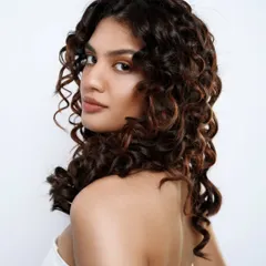 A close-up of perfectly defined, healthy curls. My goal is to enhance your natural texture, ensuring every curl is hydrated and full of life.