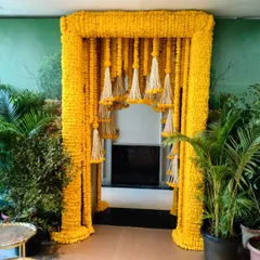 This magnificent entrance arch is made entirely of yellow marigolds, with hanging tassels of white tuberoses (rajnigandha) creating a dramatic and traditional welcome for a wedding event.