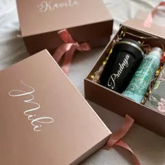 These rose gold boxes were personalized with each bridesmaid's name in elegant calligraphy, creating a truly special and personal gift.