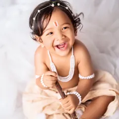 The pure, uninhibited laughter of a child is the best thing in the world. This little Krishna is having so much fun during his photoshoot, a perfect memory of his joyful spirit.