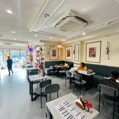 Our comfortable cafe seating area, with modern decor and soft lighting. It's the perfect spot to relax and enjoy a meal with friends or family.
