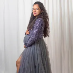 This image shows the versatility of a single session. We moved from a moody, dark setup to a clean, bright white background to provide a variety of looks with the same beautiful gown.