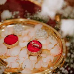 A close-up of the engagement rings, nestled in a decorative box on a bed of rose petals. I focus on capturing the beauty of these important symbols.