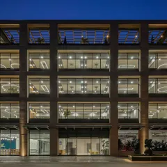 The gridded facade of Laurus Labs creates a strong architectural identity, with deep-set windows that provide shade and large floor plates for flexible office layouts.