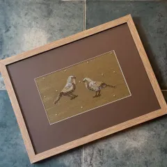 This framed Zardosi embroidery of two birds, created for us by the Monami Foundation, is a beautiful example of textile art. It blends seamlessly into the colourful world of whimsical animals and birds at our stores.