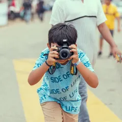 We are inspiring the next generation of Vroomers. A young fan with a camera captures the action, showcasing the family-friendly and aspirational nature of our festival.