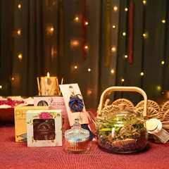 Here you can see the individual elements of my festive hamper coming together. It includes a teapot terrarium, a scented candle, handmade chocolates, and other small treasures to delight the senses.
