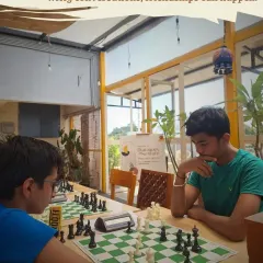 A board game battle can be the start of a new friendship. Here, two players are deep in a game of chess, surrounded by the greenery of our rooftop terrace.
