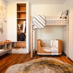 A thoughtfully designed children's room with a bunk bed and integrated storage. The space is both playful and practical, featuring a world map mural and a custom rug to spark imagination.