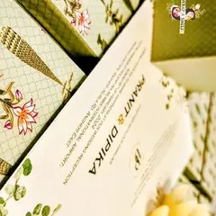 I designed this mint green invitation box with a graceful Moroccan and lotus stem theme. It includes a beautiful card and matching jars for nuts, offering a complete and elegant wedding invitation solution.