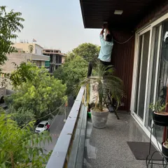 My technician carefully routes wiring for a camera on a residential balcony. We always prioritize discreet and secure cabling to maintain the look of your home while ensuring the system is tamper-proof.