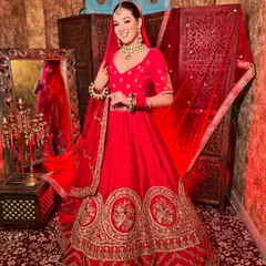 Nothing beats the timeless elegance of a classic red bridal lehenga. This piece features rich embroidery and a traditional silhouette, perfect for the bride who wants that iconic maharani look for her wedding ceremony.
