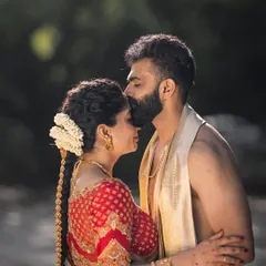 This image captures the essence of a traditional South Indian ceremony. I dressed the groom in a simple, elegant silk dhoti and angavastram (shawl), a classic look that respects heritage and pairs beautifully with the bride's vibrant red saree.