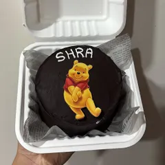 A cute Winnie the Pooh bento cake with a rich chocolate ganache finish. These mini cakes are perfect for adding a touch of sweetness to any day.
