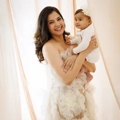 The joy on this mother's face says it all. Holding her baby close, this portrait captures a moment of pure happiness and the beautiful bond they share.