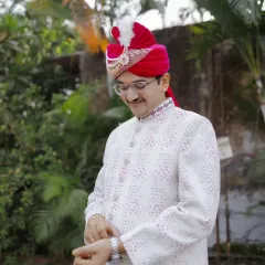 A candid shot of the groom adjusting his watch, a classic pose that adds a touch of style and anticipation.