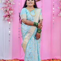 A stunning full-length portrait of the bride-to-be on her engagement day. She looks confident and beautiful in her light blue saree, with makeup and hair styled to perfection for her big moment.