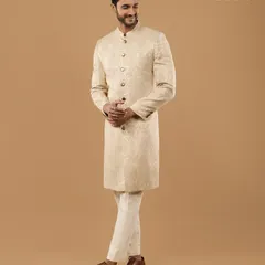 Our garments are designed not just for appearance, but for comfort and confidence. This candid shot captures the ease and perfect fit of a bespoke groom's sherwani in motion.
