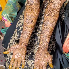 This is a beautiful example of a full bridal design that covers the arms from fingertips to elbow. The pattern is rich with florals, leaves, and shaded elements for a very full look.