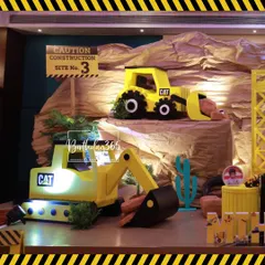 We built a whole construction site for Mihith's birthday, complete with a rock quarry backdrop and large-scale models of a CAT excavator and dump truck.