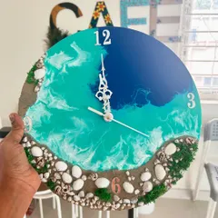This is one of my favorite custom resin art pieces, a beach-themed wall clock. You can learn to make your own in a workshop or commission a unique piece for your home, complete with real sand and shells.