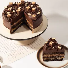 Our whole Snickers Cake, ready to be the star of your celebration. It's the perfect blend of familiar candy bar flavor and gourmet cake craftsmanship.