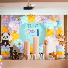 A closer view of Ditvi's pastel jungle animal party, with cute panda and tiger cutouts and a soft, colorful balloon arch.