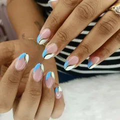 A cool and abstract take on the French manicure. This design uses blocks of white and sky blue, separated by a fine gold line, to create a modern and graphic tip.