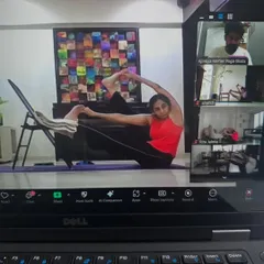 This student is using a chair to work on her flexibility in our online hip-opening class. Props are great tools, even when you are practicing from home.