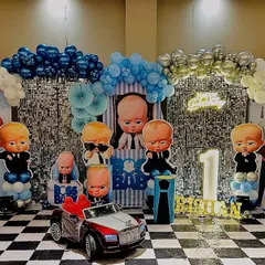 Here is a full view of one of my popular Boss Baby themed decorations. The setup includes a wide shimmer backdrop, a complete set of character cutouts, themed balloon columns, and a checkered floor to match the theme's style.
