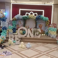 A behind-the-scenes look at a "Wild One" jungle theme setup in progress. You can see the animal cutouts and balloon pillars coming together to create a safari adventure.