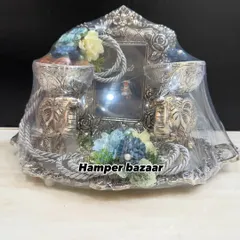Our German silver platter hamper is a statement of pure elegance. It features two elephant-shaped bowls for dry fruits and a photo frame, making it a luxurious and reusable gift for Diwali or weddings.