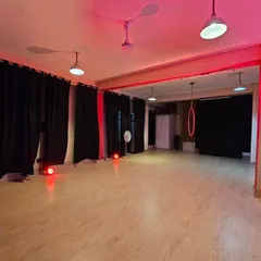 The space transformed with a dramatic red light. This demonstrates how you can use our spot lamps and RGB lights to create a powerful, focused atmosphere for performance pieces or themed photoshoots.